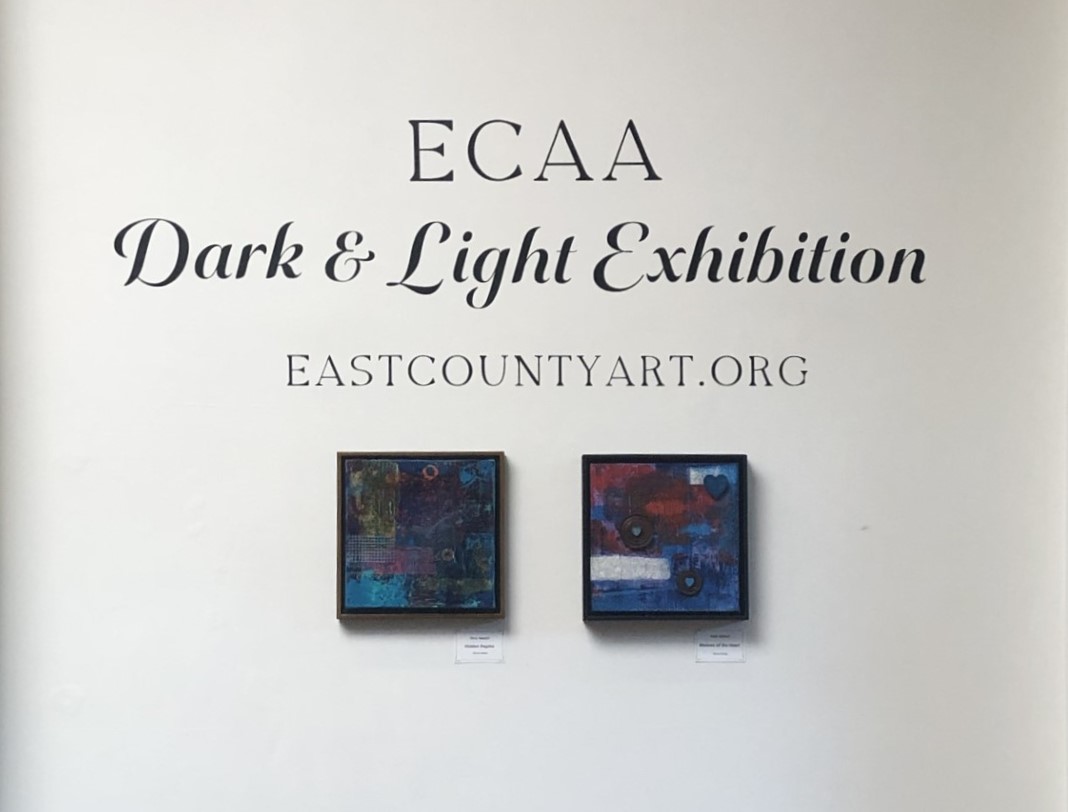 White wall with two painting of abstract art with the title, ECAA Dark & Light Exhibition EASTCOUNTYART.ORG, above the painting